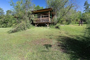 A wooden cabin with a balcony, surrounded by trees and grass. - Chalet 2 at Laupié near Sarlat (Proissans)