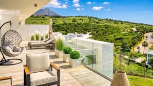 A balcony with a view of a green landscape and a mountain. - 3118 Luxury Penthouse with Panoramic Views (Casares)