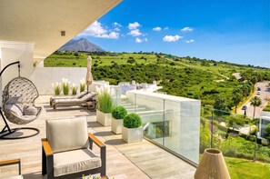 A balcony with a view of a green landscape and a mountain. - 3118 Luxury Penthouse with Panoramic Views (Casares)