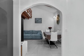 A modern interior with a dining area, a sofa, and a staircase. - ☀️ In the heart of Rue Meynadier & Palais (Cannes)