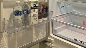 An open refrigerator with clear shelves, a water dispenser, and a milk carton. - Peaceful 2BR Stay with Fast Reliable Wi-Fi (Kingston upon Hull)