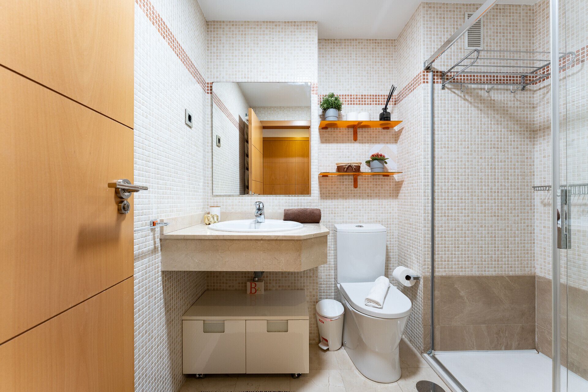 A bathroom with a sink, toilet, and shower.
