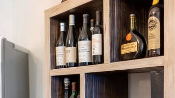 A wooden wine rack with bottles of wine.