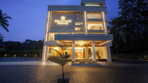 A multi-story building with a prominent sign reading 'Grand Royal Residency.' -  Hotel Grand Royal Paika (POOVARANI)