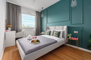 A modern bedroom with a bed, bedside table, and a view of the outside. - Lumina Apart nearManufartura and Parking (Łódź)