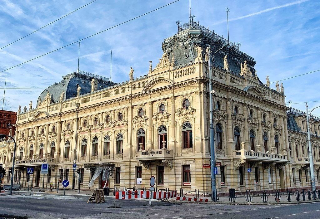 A historic building with ornate architecture, large windows, and a prominent dome.