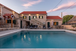 A stone building with a swimming pool, outdoor seating, and a lifebuoy. - Villa Zvonimir Zadarvillas (Promina)