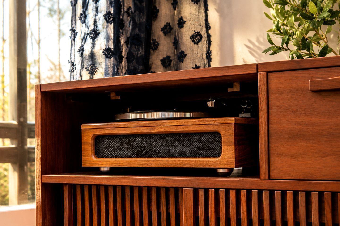 Un mueble de madera con un tocadiscos incorporado y un altavoz.