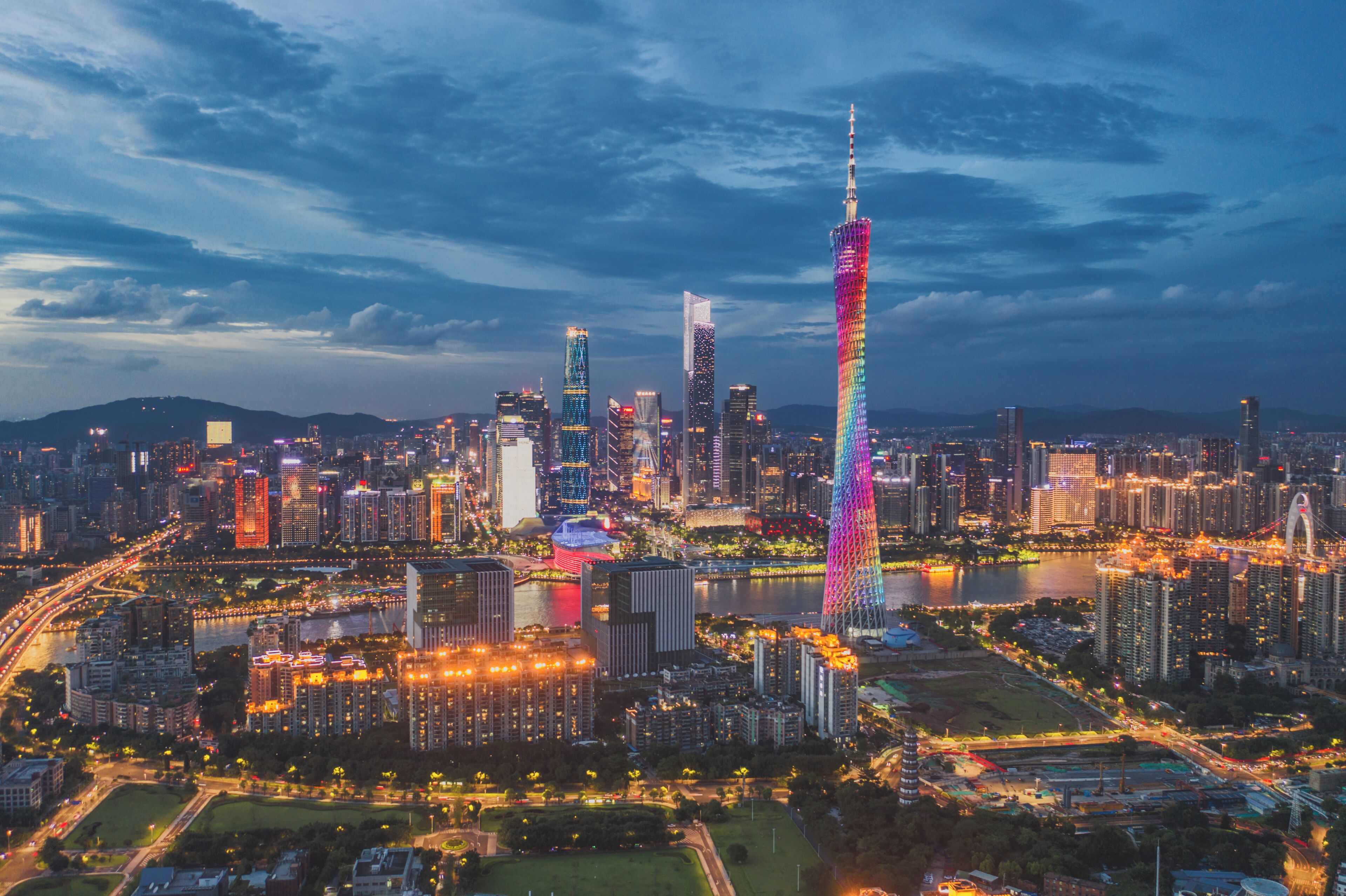 A cityscape with a prominent tower and surrounding high-rise buildings.