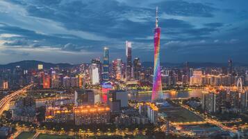 A cityscape with a prominent tower and surrounding high-rise buildings.