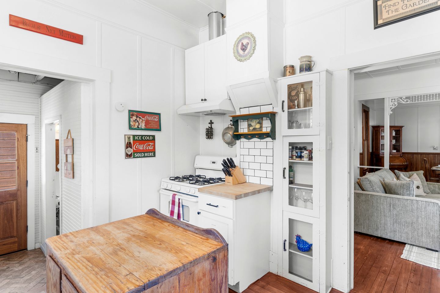 A kitchen with a stove, cabinets, and a dining table.