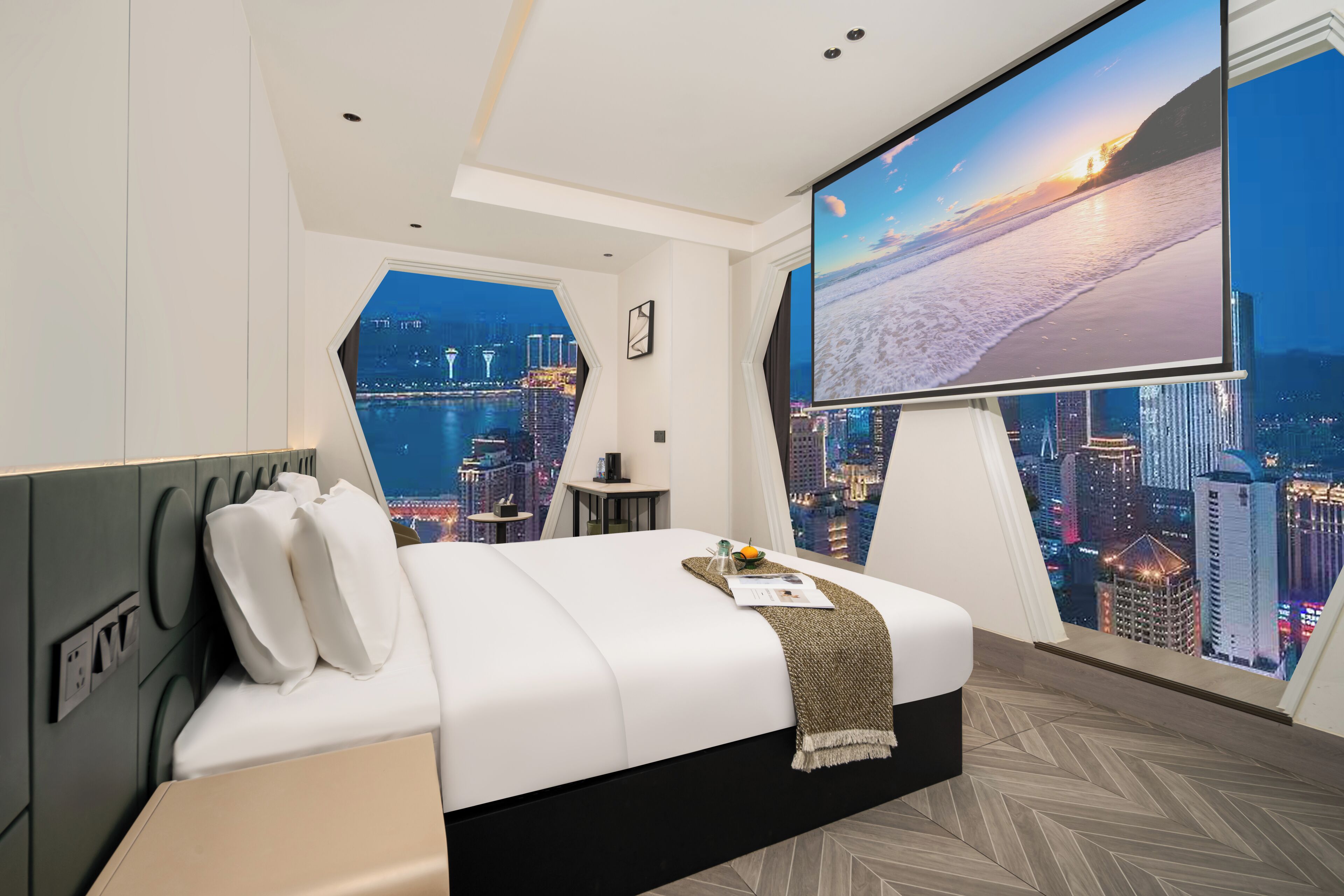 A modern hotel room with a large bed, a TV, and a city view.
