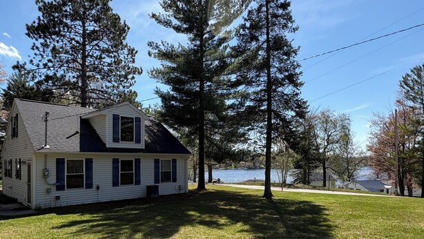 A single-story house with a sloped roof, a visible chimney, and a front porch. - Amazing hilltop views of gorgeous Sage Lake with beach and boat launch access. (Hale)