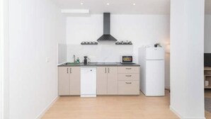 A modern kitchen with a dishwasher, a microwave, and a refrigerator.