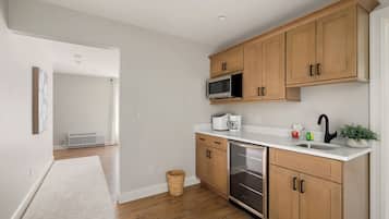 Fridge, microwave, coffee/tea maker, cookware/dishes/utensils