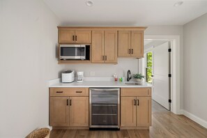 Fridge, microwave, coffee/tea maker, cookware/dishes/utensils