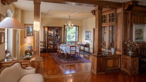 A spacious dining area with a wooden table, chairs, and a chandelier. - 300-square-meter villa · 6 bedrooms & 5 bathrooms · Cool in the summer (Bibbiena)