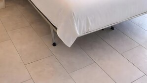 A single-bed room with a bunk bed above, white bedding, and a pair of rolled towels on the bed. - Apartment 'Perla' with Sea View, Balcony and Air Conditioning (Agrustos)