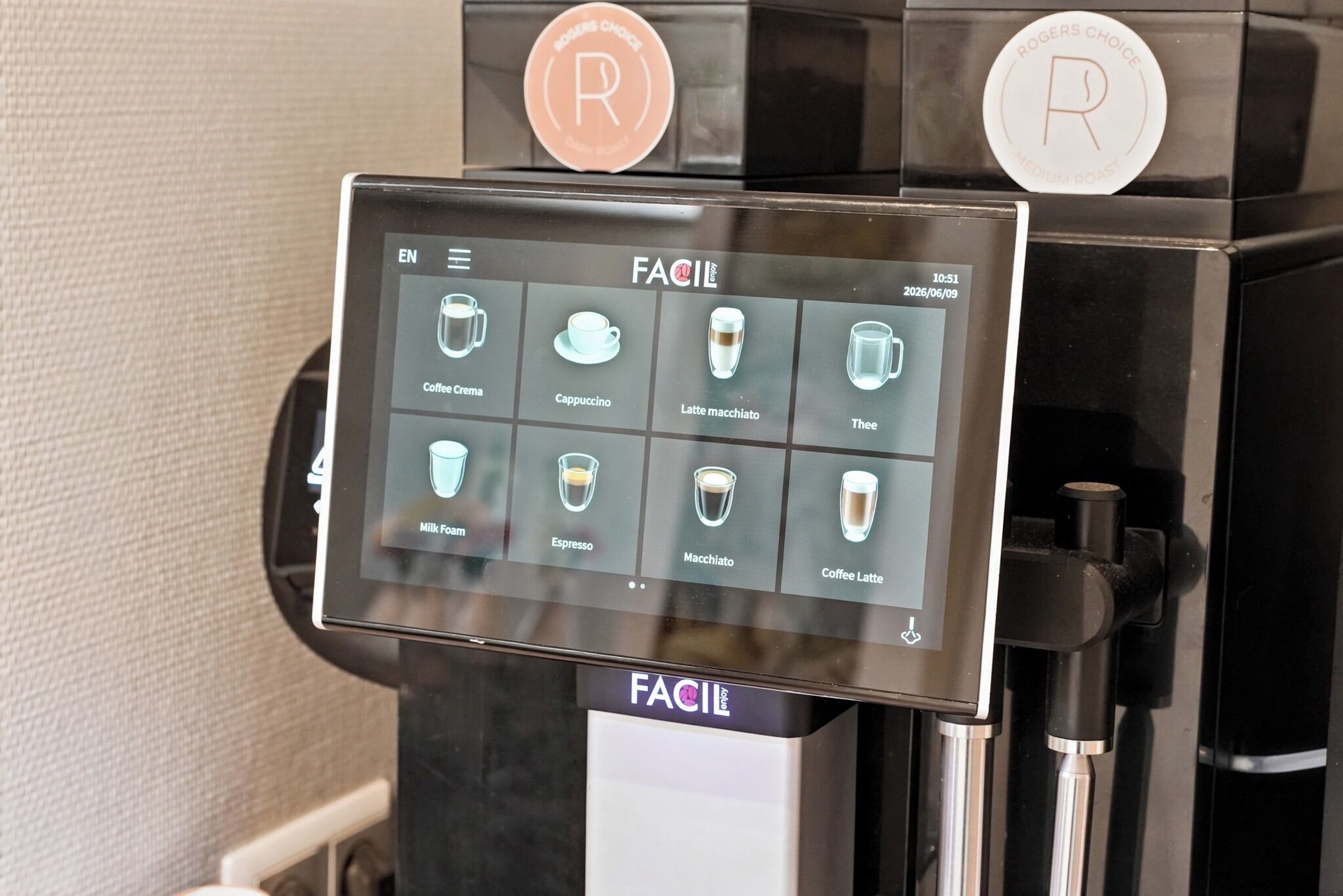 A coffee machine with a touchscreen menu displaying various coffee options.