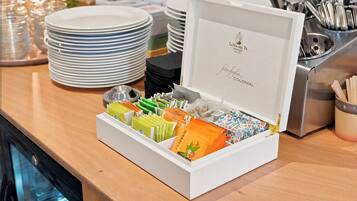 A buffet setup with a variety of food items and utensils.