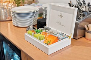 A buffet setup with a variety of food items and utensils.