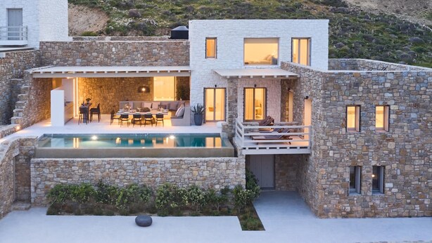 A modern stone house with a swimming pool, outdoor seating, and a patio area. - Villa Poeme Kalo Livadi Mykonos (Mykonos)