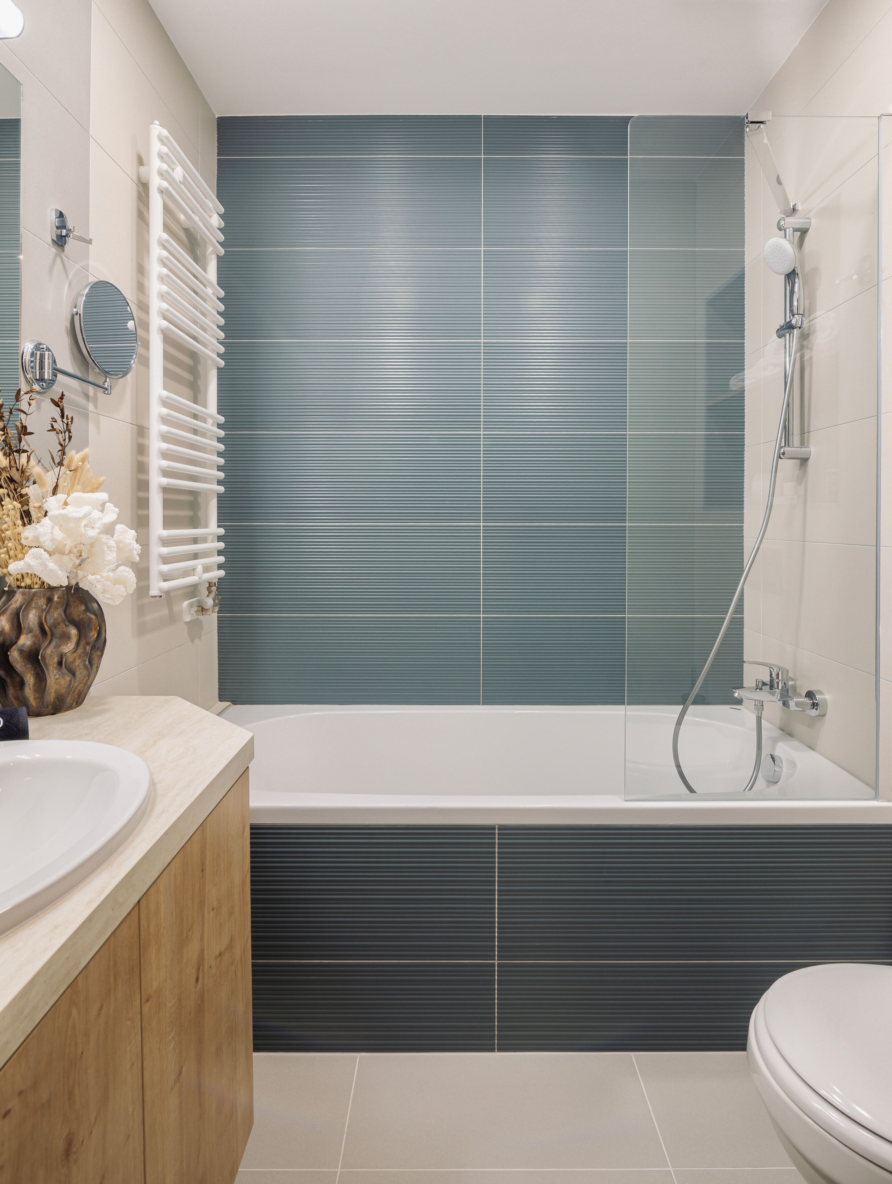 A modern bathroom with a bathtub, a shower, and a vanity with two sinks.