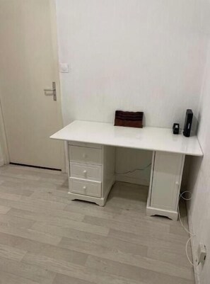A white desk with drawers, a small wooden box, and a black object on the desk. - Swiss border 10 minutes from downtown Geneva 50m from tramway (Gaillard)