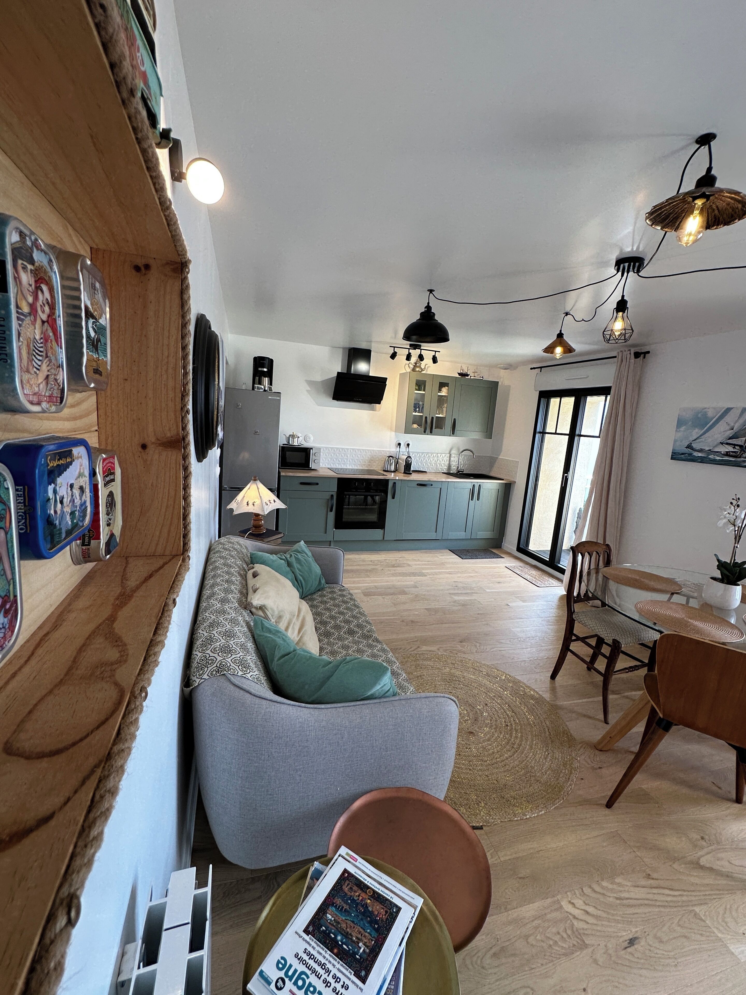 A modern kitchen with a microwave, stove, and cabinets. There is a dining area with a table and chairs.