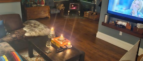 A cozy living room with a fireplace, a television, and a comfortable seating area.