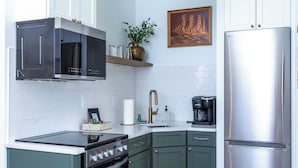 A kitchen with a built-in stove, oven, microwave, and stainless steel refrigerator.