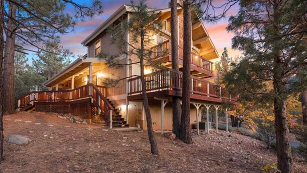 A multi-story wooden house with a porch and stairs leading to the entrance. - Hot Tub, Near Bear Mt, Lake Views, Dog Yard, AC (Big Bear Lake)