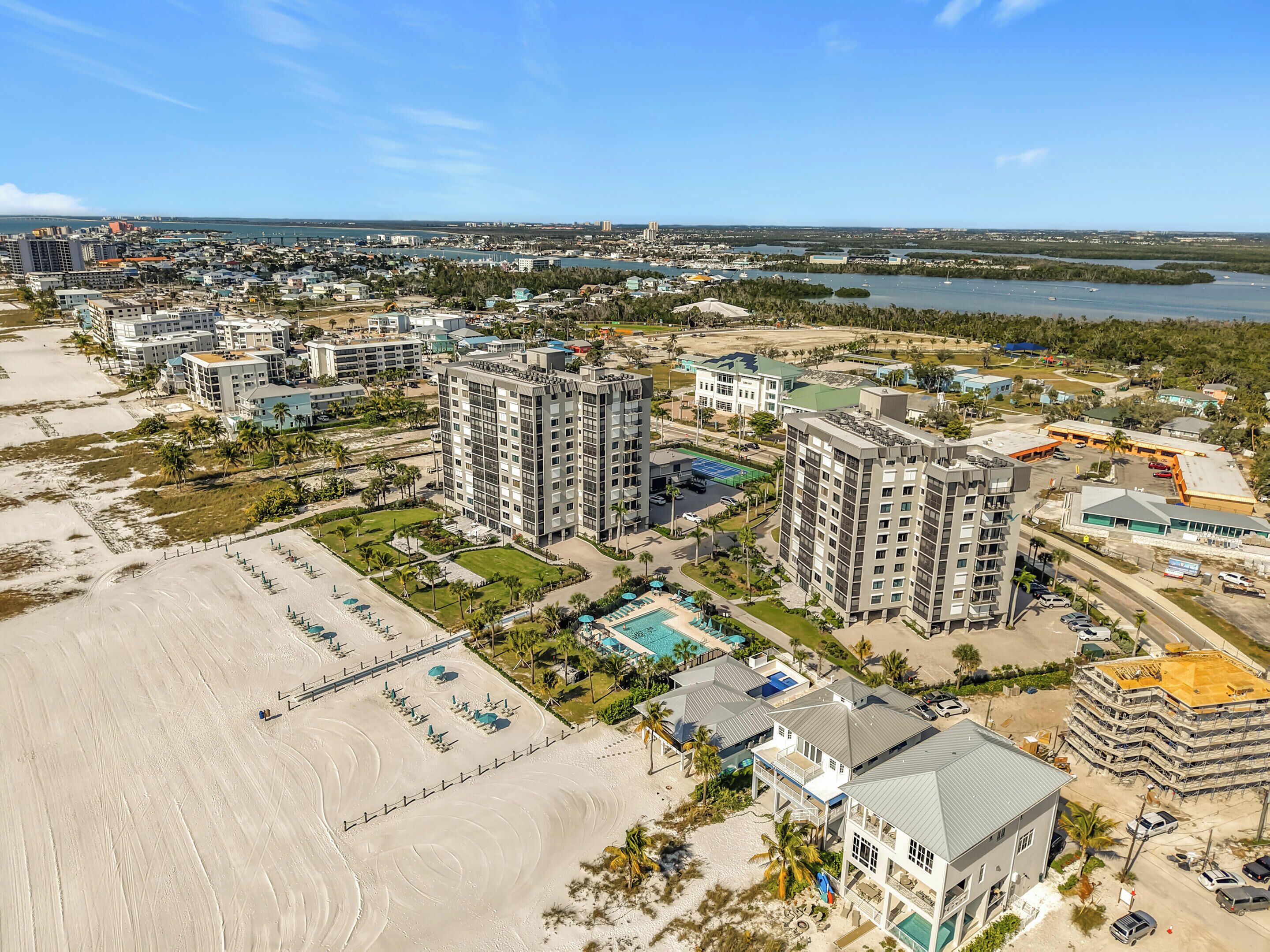 A coastal hotel complex with multiple high-rise buildings, a beach area, and a marina.