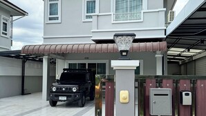 A two-story house with a garage, a black SUV parked in the driveway, and a mailbox on the front wall. - Your ultimate modern escape awaits at NS House. (Khlong Hae Subdistrict, Hat Yai District)