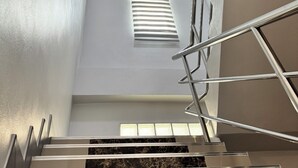 A modern staircase with metal railings, marble steps, and a skylight. - Your ultimate modern escape awaits at NS House. (Khlong Hae Subdistrict, Hat Yai District)