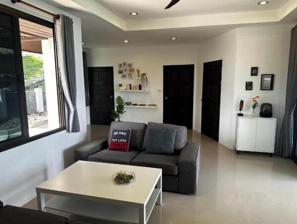 A modern living room with a sofa, a coffee table, and a cabinet.