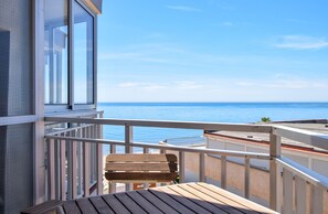 A balcony with a view of the sea, wooden furniture, and a white railing. - Ref: 230. Fully renovated seafront studio with pool (Fuengirola)