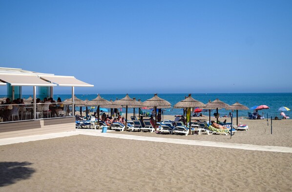 A beachside hotel with sun loungers, umbrellas, and a pool area. - Ref: 230. Fully renovated seafront studio with pool (Fuengirola)