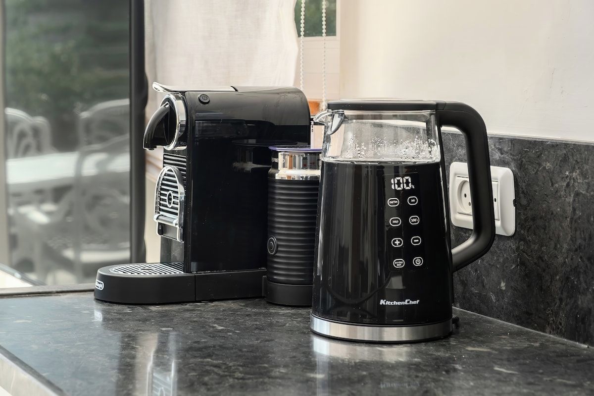 A coffee maker and a kettle on a kitchen counter.