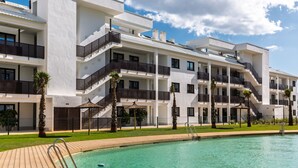 A modern hotel with a swimming pool, multiple balconies, and a well-maintained garden. - AS EXT Higueron Lomas 4-2b (Fuengirola)