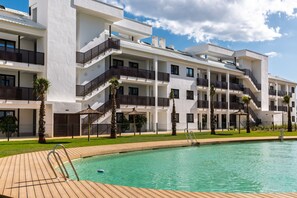 A modern hotel with a swimming pool, multiple balconies, and a well-maintained garden. - AS EXT Higueron Lomas 4-2b (Fuengirola)