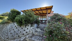 A traditional Japanese-style building with a wooden roof and stone steps leading to a wooden deck. - S362 – Sirolo, wonderful four-room apartment with garden (Sirolo)