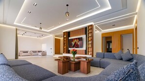 Un salon moderne avec un canapé d’angle, une table basse en bois et une cheminée.