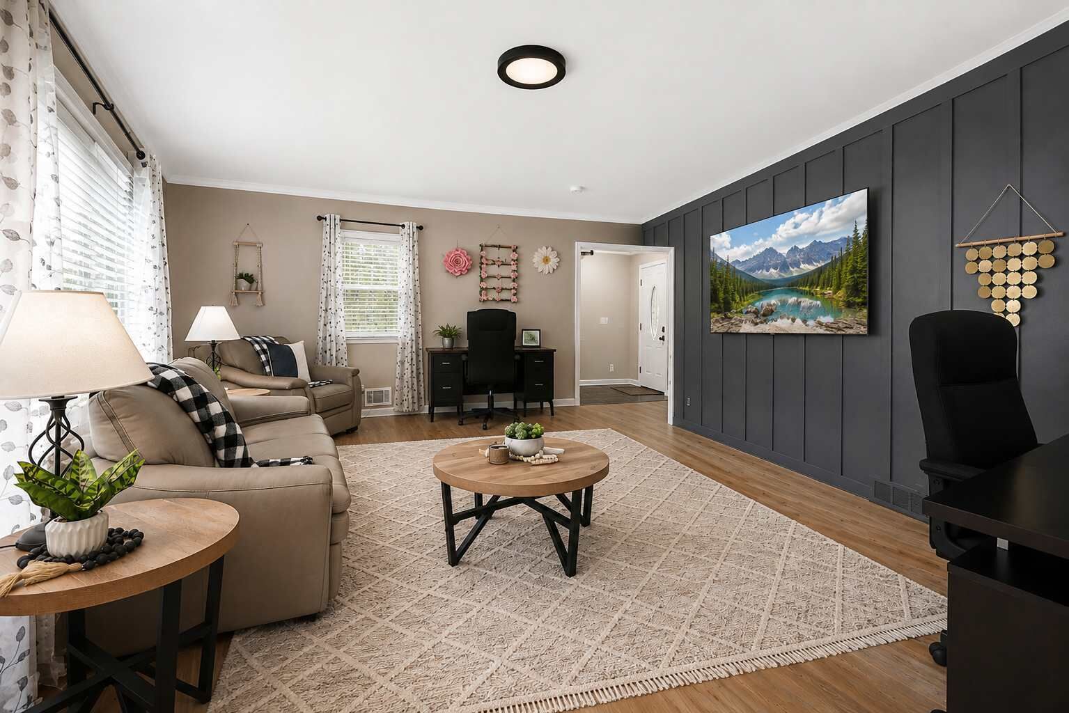 A living room with a sofa, coffee table, and a painting on the wall.