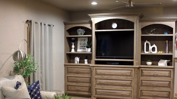 A living room with a sofa, coffee table, and entertainment unit. - The Diamond Suite is our flagship luxury suite. (Fredericksburg)