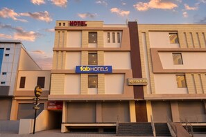 A modern hotel building with 'fabHOTELS' signage, a restaurant sign, and 'AQUEN PLAZA' on the facade. - FabHotel Aqueens Plaza - Near Jawahar Circle, Patrika Gate (Jaipur)