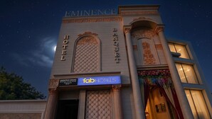 A hotel with a prominent 'Eminence Hotel' sign, a 'Fab Hotels' sign, and a balcony with decorative flowers. - FabHotel Eminence Grand (New Delhi)