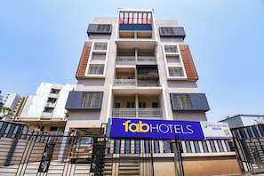 A multi-story building with a sign for 'fabHOTELS' and 'HIMALAY GUEST HOUSE' indicating a hotel property. - Fabhotel Himalay Guest House (Pune)