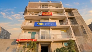 A multi-story hotel with a reception area, balconies, and a sign indicating a hotel HR residency. - Fabhotel Hr Residency (New Delhi)