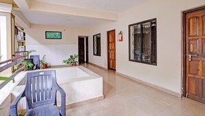 A spacious hallway with a bathtub, wooden doors, and potted plants. - FabHotel Kartik Resort - 150M From Mandrem Beach (Mandrem)